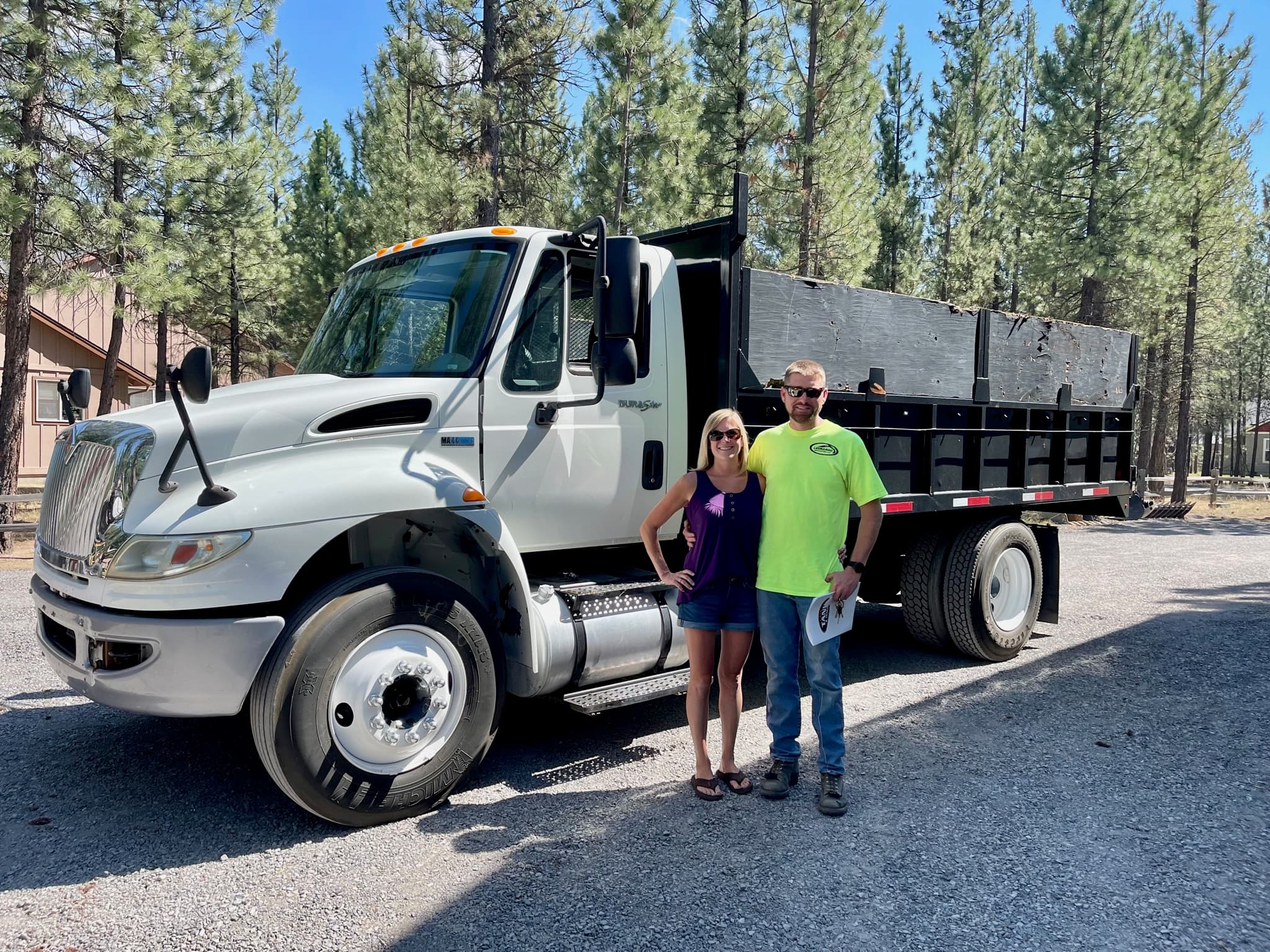 Luke and Cassie Leonardo, owners of Leonardo Excavation, in front of their dump truck